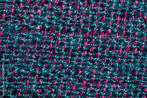 Fabric macro texture. knitted textile close up. woven background. woolen material. weaving blue and red threads