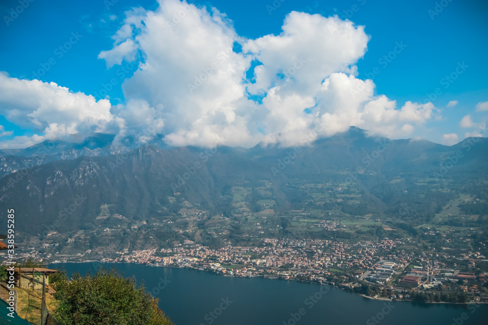 View from Monte Isola Island and mountain in Lombardy, Northern Italy on the small towns of Sulzano and Sale Marasino. View from a high point of the hike to Madonna della Ceriola Church