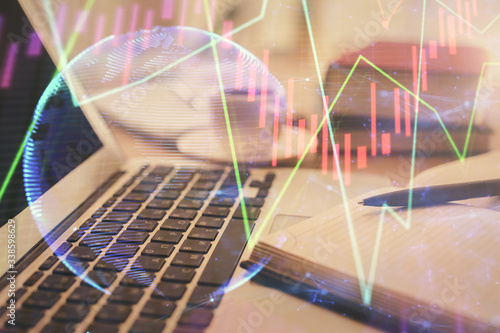 Double exposure of financial chart drawing and desktop with coffee and items on table background. Concept of forex market trading