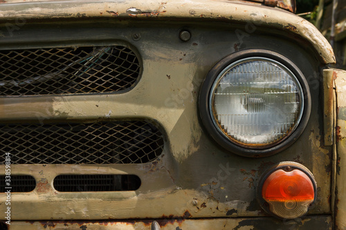 Headlight of an old Soviet military vehicle. Car detail. Close-up