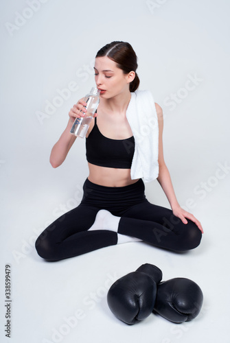Young woman is resting after boxing workout.