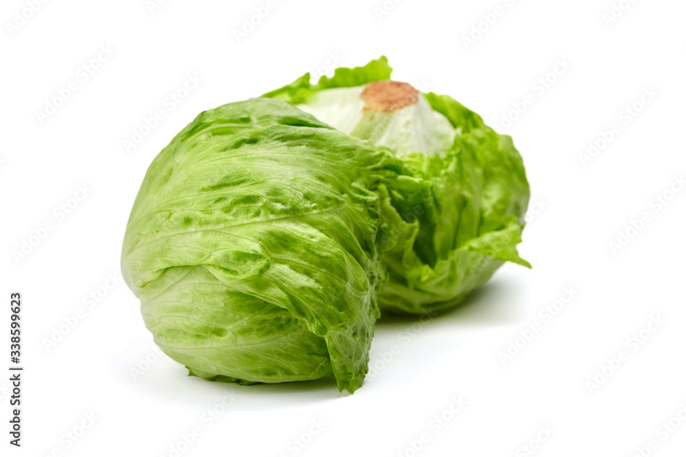 Crisphead lettuce, two whole heads of iceberg lettuce, leafy green vegetables isolated on white background Crisphead lettuce, two whole heads of iceberg lettuce, leafy green vegetables isolated on white background