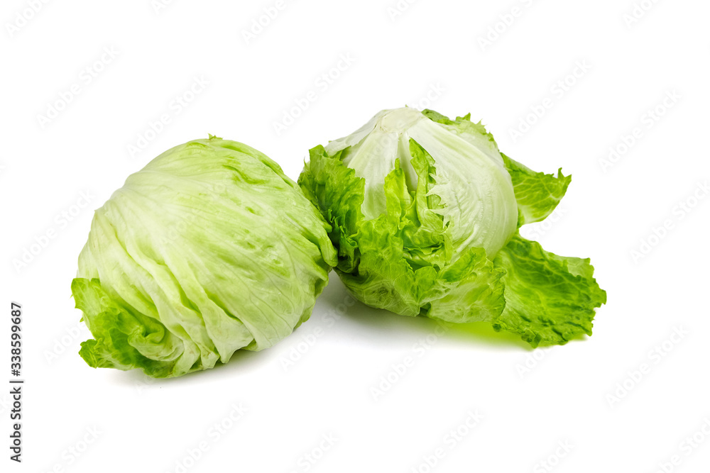 Crisphead lettuce, two whole heads of iceberg lettuce, leafy green vegetables isolated on white background Crisphead lettuce, two whole heads of iceberg lettuce, leafy green vegetables isolated on white background