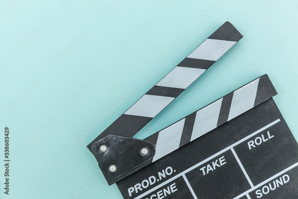 Filmmaker profession. Classic director empty film making clapperboard or movie slate isolated on blue background. Video production film cinema industry concept. Flat lay top view copy space mock up.