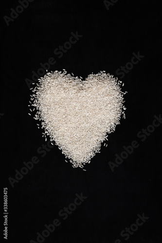 heart made of rice on dark background