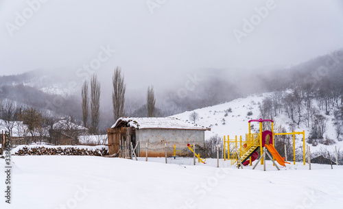 Empty playground, winter landscape, misty mountains. March 18, 2020 Turkey