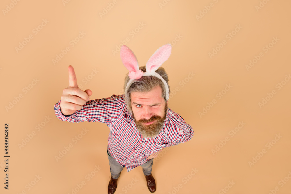 Easter man points finger on copy space. Sale. Discount. Season sales. Happy Easter. Man in bunny ears. Rabbit man. Man in rabbit ears. Springtime. Holidays. Preparation for Easter. Easter man points finger on copy space. Sale. Discount. Season sales. Happy Easter. Man in bunny ears. Rabbit man. Man in rabbit ears. Springtime. Holidays. Preparation for Easter.