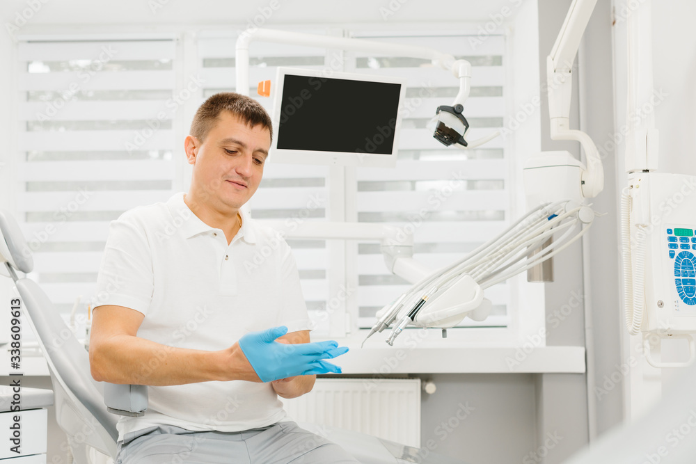 Man dentist at his working place