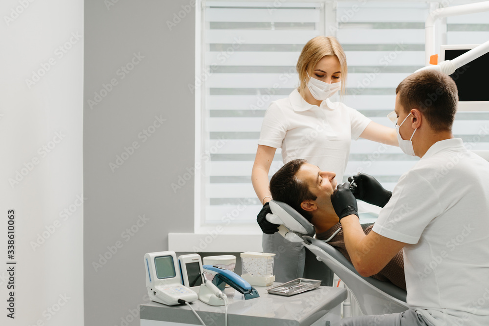 Doctor Dentist with an assistant work in a dental clinic. Doctor Dentist with an assistant work in a dental clinic.