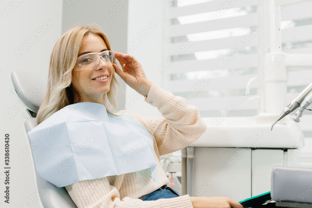 Woman looking at her teeth. Smiling lady at dentist office. Woman looking at her teeth. Smiling lady at dentist office.