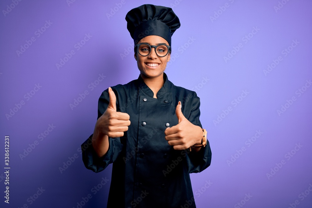 Young african american chef girl wearing cooker uniform and hat over purple background success sign doing positive gesture with hand, thumbs up smiling and happy. Cheerful expression and winner Young african american chef girl wearing cooker uniform and hat over purple background success sign doing positive gesture with hand, thumbs up smiling and happy. Cheerful expression and winner