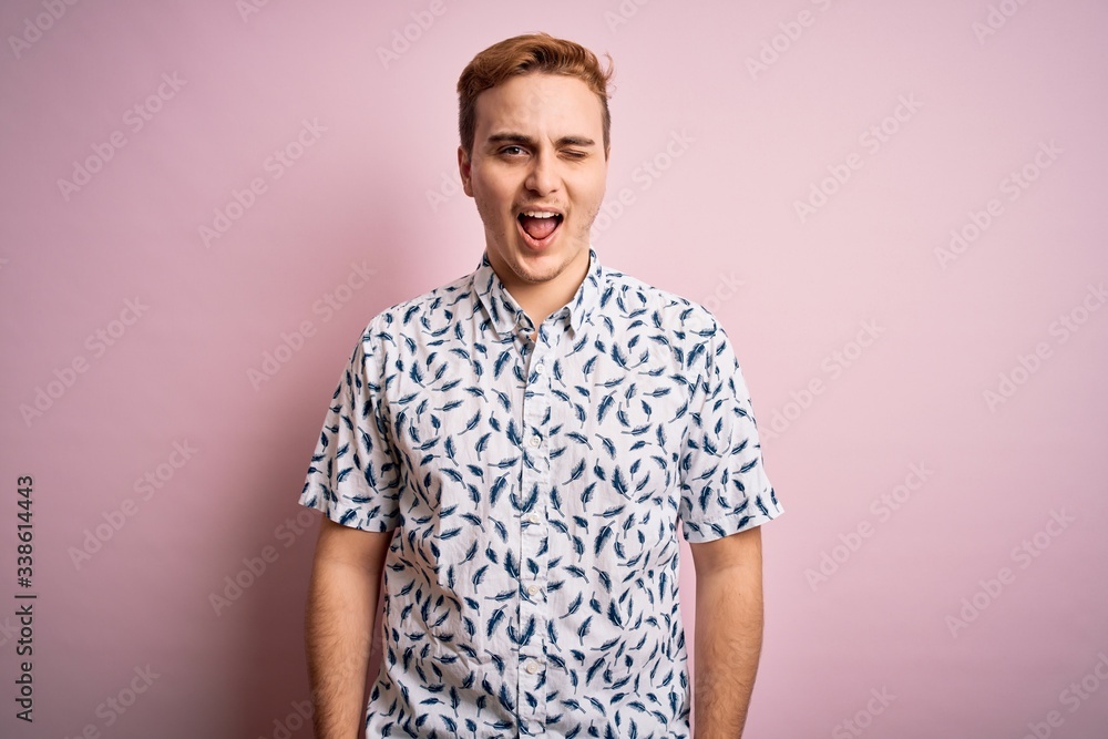 custom made wallpaper toronto digitalYoung handsome redhead man wearing casual summer shirt standing over pink background winking looking at the camera with sexy expression, cheerful and happy face.