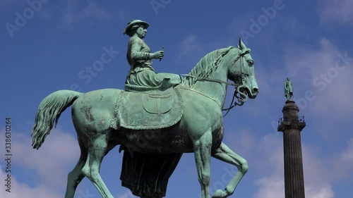 Statue of woman suffrage against blue sky UK