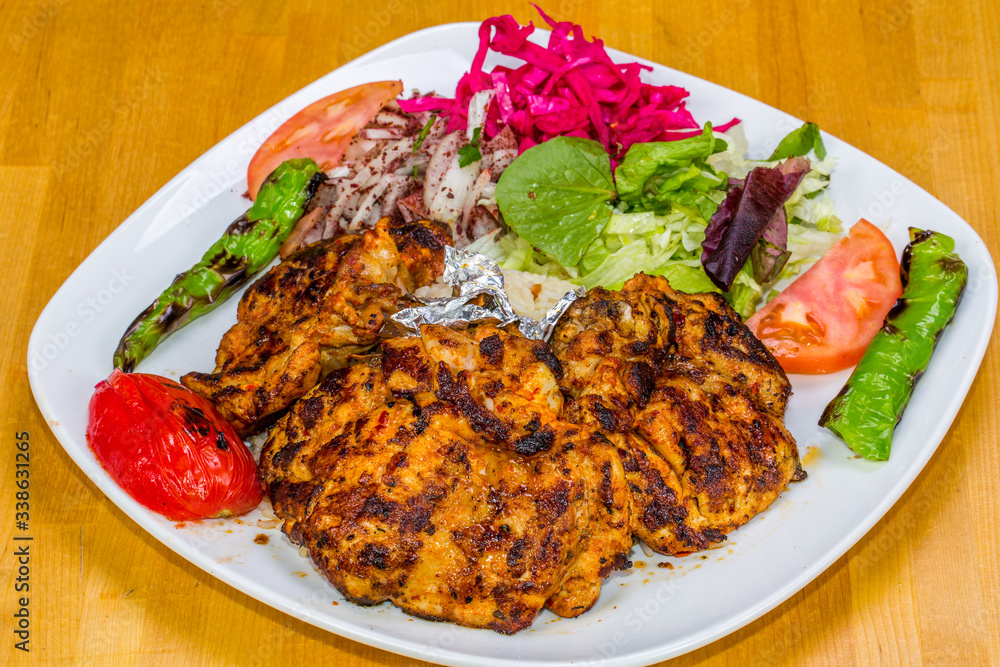 Turkish cuisine. Chicken chop on bone (pirzola) with vegetables Turkish cuisine. Chicken chop on bone (pirzola) with vegetables