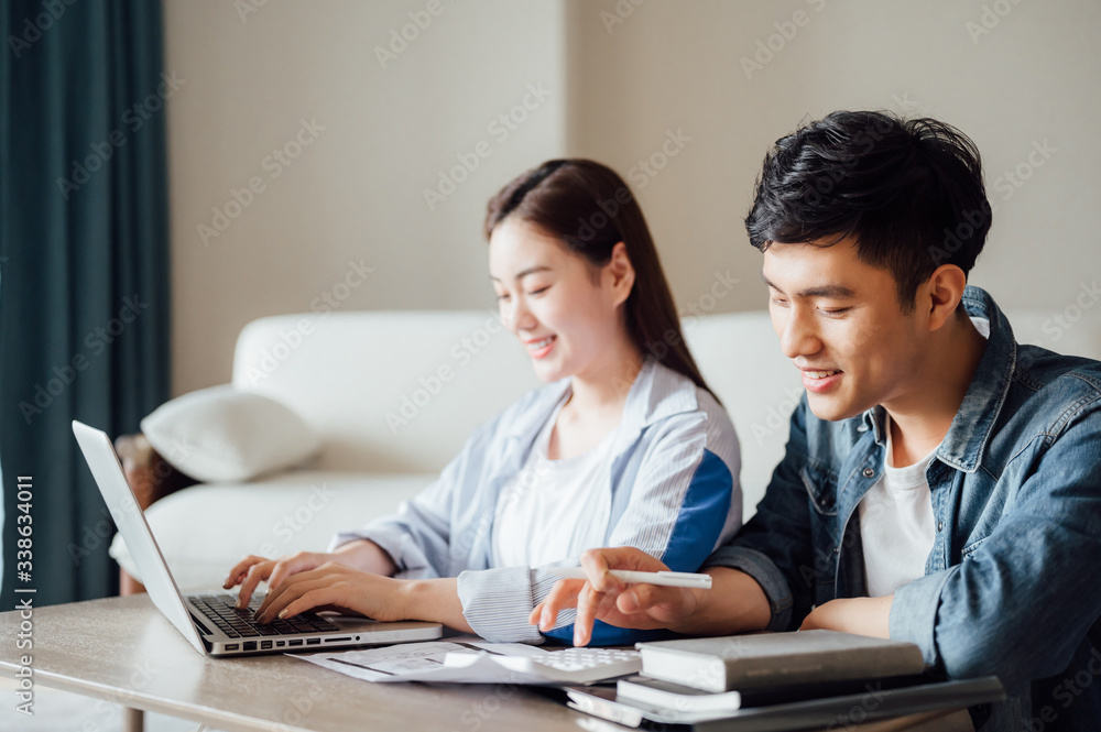 Young Asian couple at home using computer Young Asian couple at home using computer