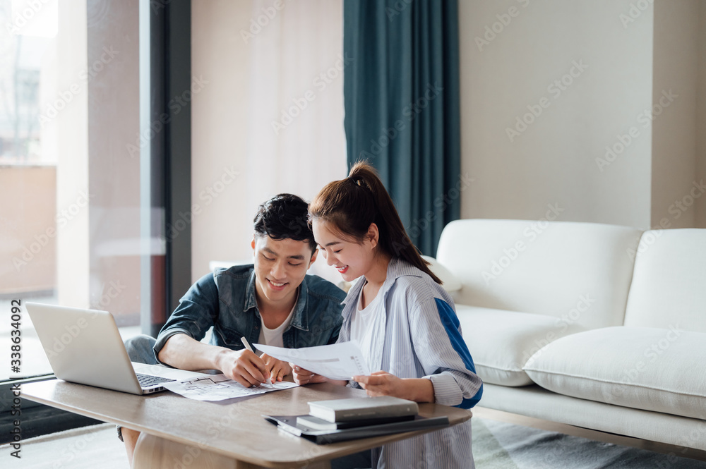 Young Asian couple at home using computer Young Asian couple at home using computer