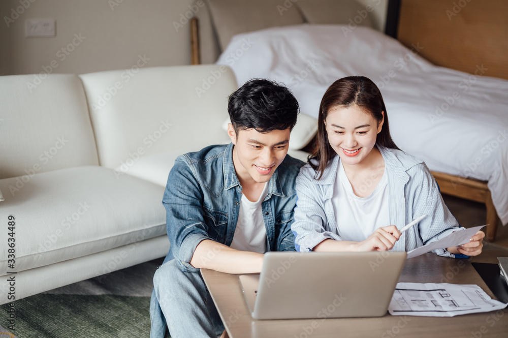 Young Asian couple at home using computer Young Asian couple at home using computer
