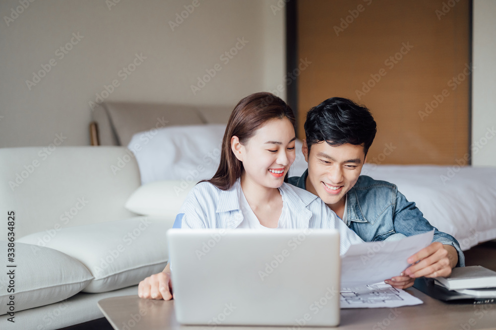 Young Asian couple at home using computer Young Asian couple at home using computer