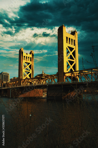 Downtown Sacramento skyline and dramatic cloudy sunset behind Tower Bridge