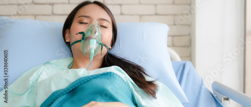 asian woman patient on bed in hospital with wearing oxygen mask photo
