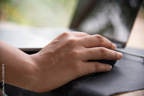 Close up hand women using laptop.