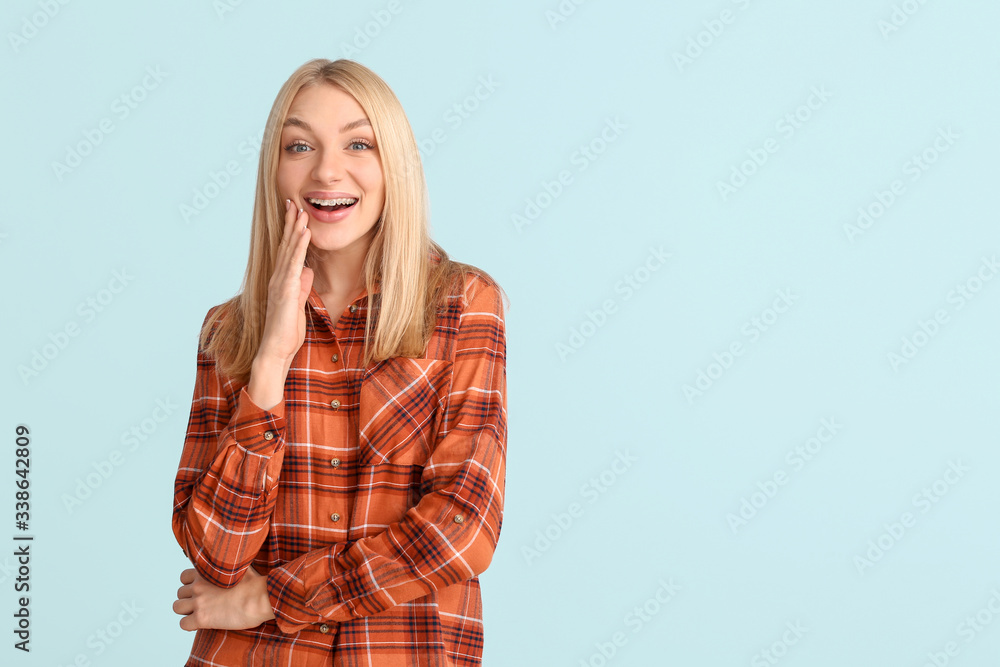 Happy woman with dental braces on color background Happy woman with dental braces on color background