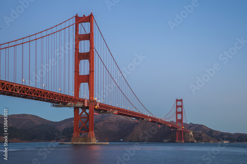 The famous Golden Gate Bridge in San Francisco, California. Beautiful sunlight hitting the bridge as cars drive over it. 