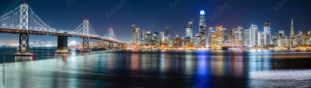 Nighttime view of San Francisco city. Calm and peaceful conditions in the bay as the city light illuminate the water. 