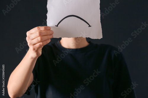 Woman holding paper sheet w...