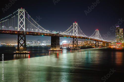 Nighttime view of San Francisco city. Calm and peaceful conditions in the bay as the city light illuminate the water. 