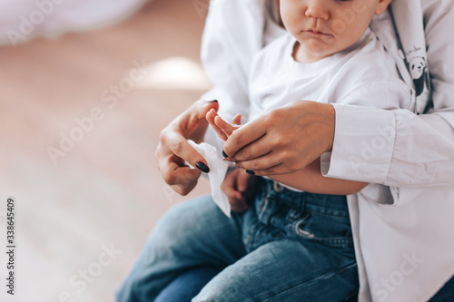 Mother and child wipe their hands with disinfectant wipes, how to wipe their hands, how to sit in quarantine, health care