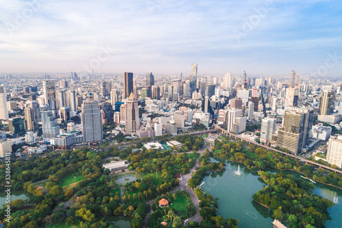 Bangkok downtown city office building with green park sunset aerial view