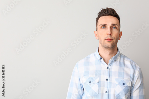 Portrait of handsome man on light background © Pixel-Shot