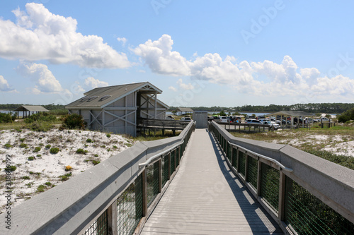 beach boardwalk over sand dunes with blue sky background at santa rosa florida state park 