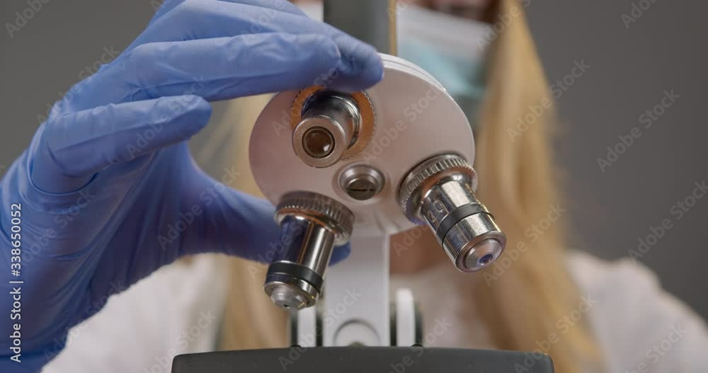 Close-up of the lens is changing in the microscope. Work in the lab. 4K Close-up of the lens is changing in the microscope. Work in the lab. 4K