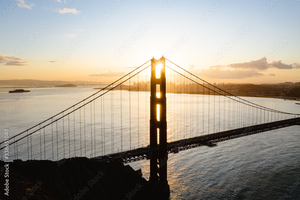 Aerial drone image of the Golden Gate bridge with an epic sunset behind it. Iconic landscape location. 