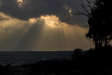 A shot of Cloudscape illuminated by sun over the Indian Ocean and beach silhouette
