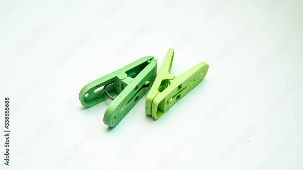 Green clothespins or clothes pegs isolated on a white background. Green clothespins or clothes pegs isolated on a white background.