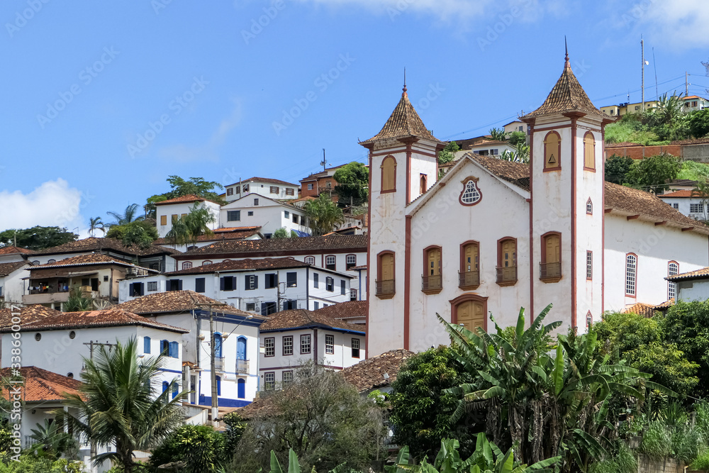 Front view of an impressive colonial church and buildings in historical town Serro on a sunny day, Minas Gerais, Brazil
