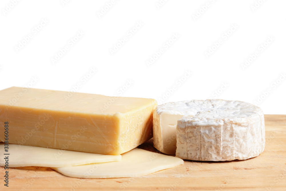Different types of cheese on the wood with brown paper background.