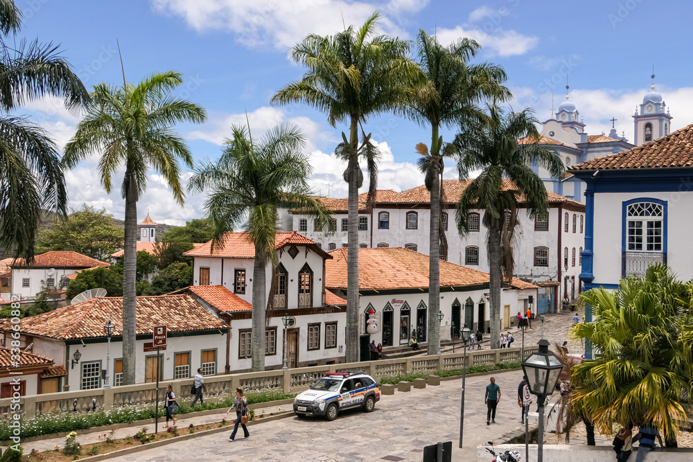 View to traditional houses and palm tree lined street in historic center of Diamantina on a sunny day, Minas Gerais, Brazil