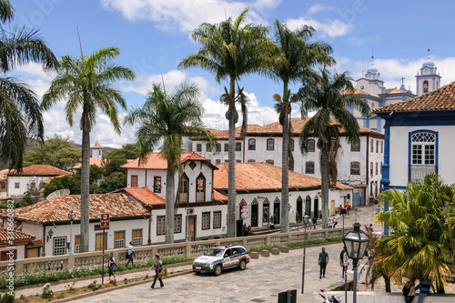 View to traditional houses and palm tree lined street in historic center of Diamantina on a sunny day, Minas Gerais, Brazil photo