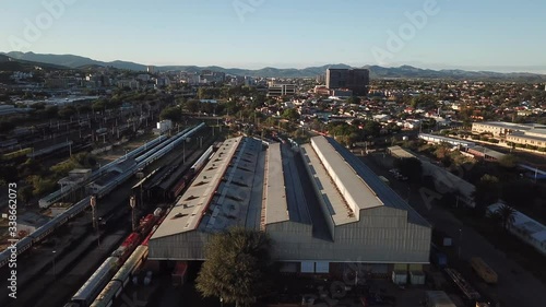 4K aerial Windhoek capital main railway station depot sheds, workshops and railway lines with trains parked area at bright sunrise drone video in Khomas Region, central Namibia photo