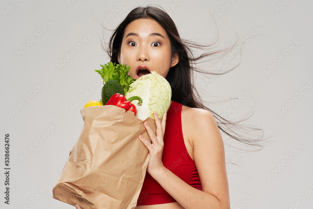 young woman holding a bunch of vegetables young woman holding a bunch of vegetables