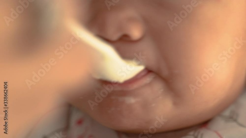 Wallpaper Mural mother feeding baby. asian woman feed her baby at home Torontodigital.ca