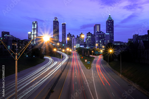 Atlanta, Georgia city skyline from Jackson Street Bridge at night. Sunset twilight sky with car light trails. © Patrick
