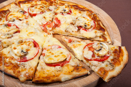 Pizza with cheese, tomatoes and mushrooms