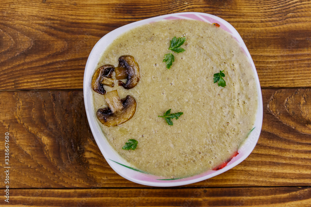 Mushroom cream soup on a wooden table. Top view Mushroom cream soup on a wooden table. Top view