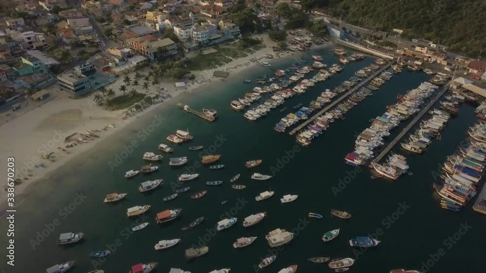 Aerial view of picturesque Arraial do Cabo town with the many boats on the marina during golden hour, tilt up shot Aerial view of picturesque Arraial do Cabo town with the many boats on the marina during golden hour, tilt up shot