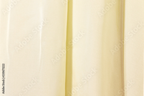 Yellow curtain lace, abstract texture background. Beige curtain. Synthetic fabric texture.